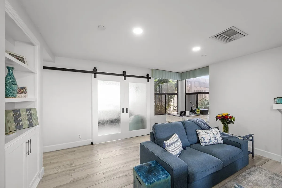 1125 Pacific Beach Drive, Unit 104 San Diego, CA 92109 - Photo 12 of 67 a living room with furniture and a wooden floor