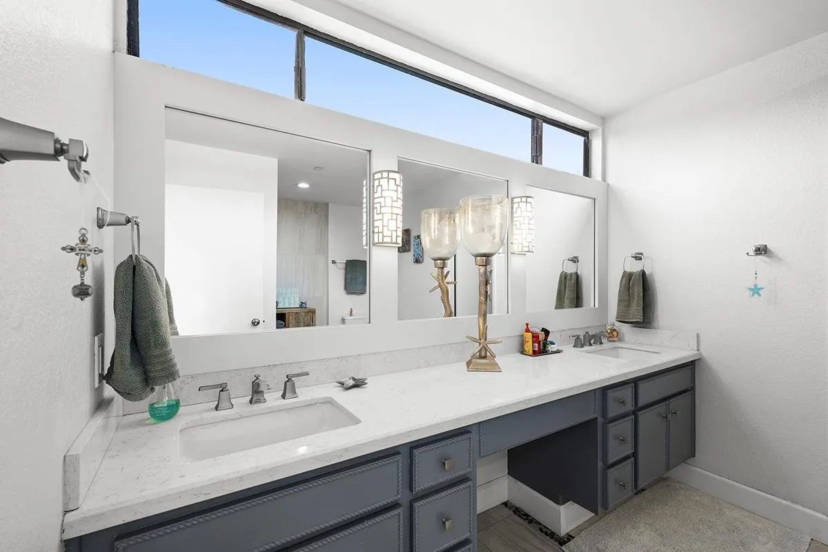 1125 Pacific Beach Drive, Unit 104 San Diego, CA 92109 - Photo 24 of 67 a bathroom with a sink double vanity and a mirror