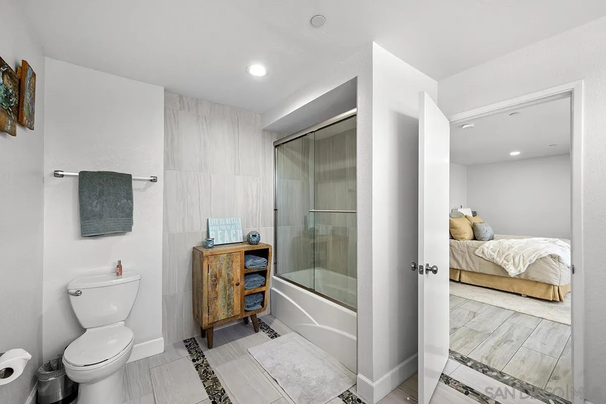 1125 Pacific Beach Drive, Unit 104 San Diego, CA 92109 - Photo 25 of 67 a en suite bathroom with a toilet sink and mirror