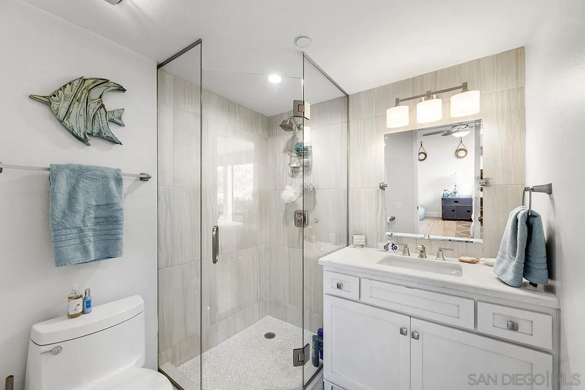 1125 Pacific Beach Drive, Unit 104 San Diego, CA 92109 - Photo 27 of 67 a bathroom with a sink a toilet and shower