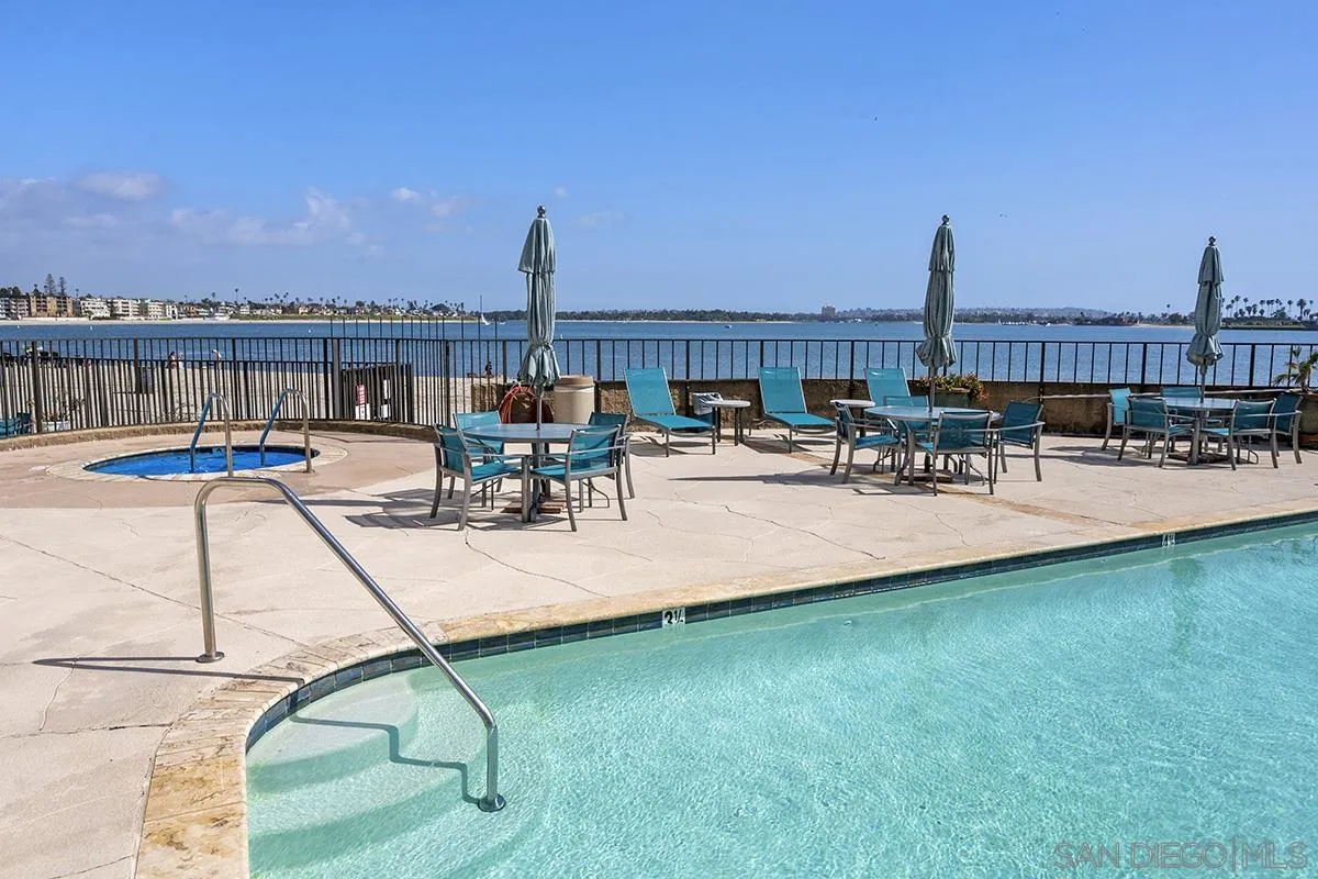 1125 Pacific Beach Drive, Unit 104 San Diego, CA 92109 - Photo 35 of 67 a view of a patio with chairs and table on wooden floor