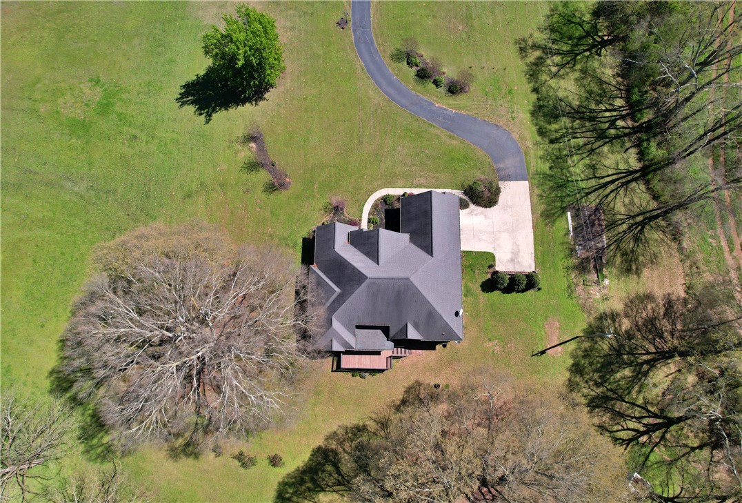 7893 Athens Road Carnesville, GA 30521 - Photo 45 of 50 This property features a winding driveway and a vast green expanse, offering privacy and natural beauty.