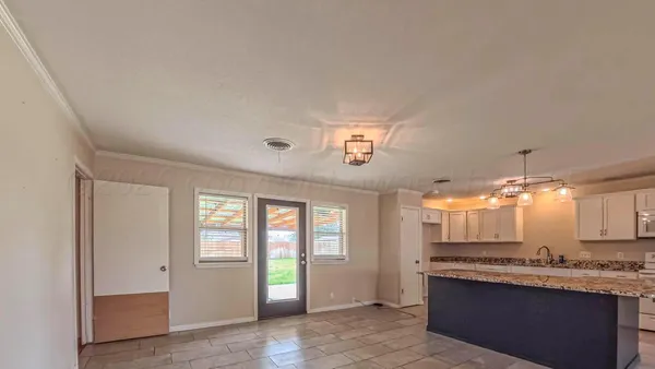 a view of a kitchen with a sink and a window