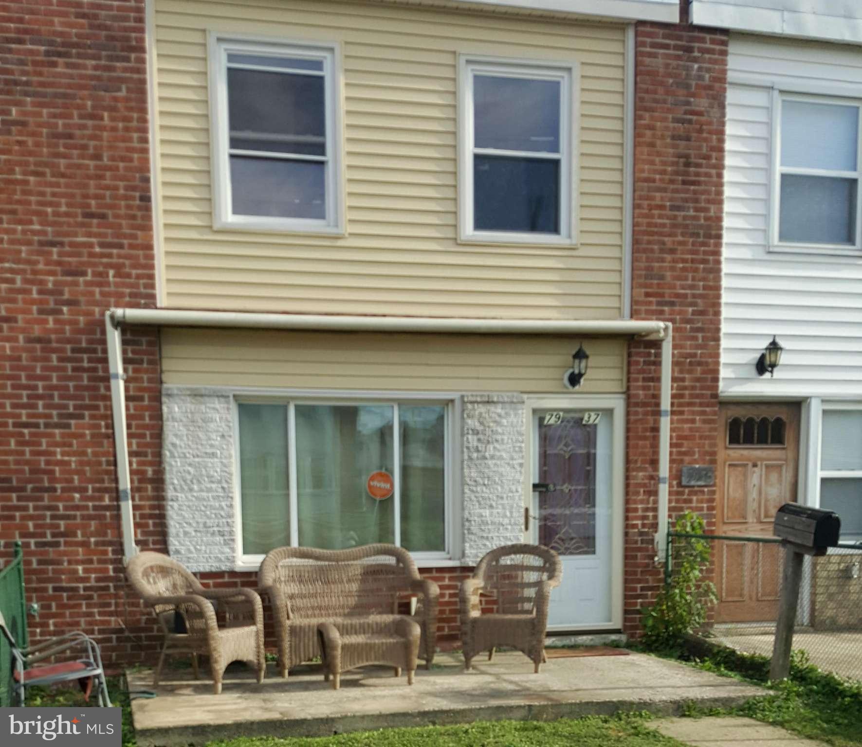 7937 Wynbrook Road Baltimore, MD 21224 - Photo 2 of 3 a front view of a house with outdoor seating