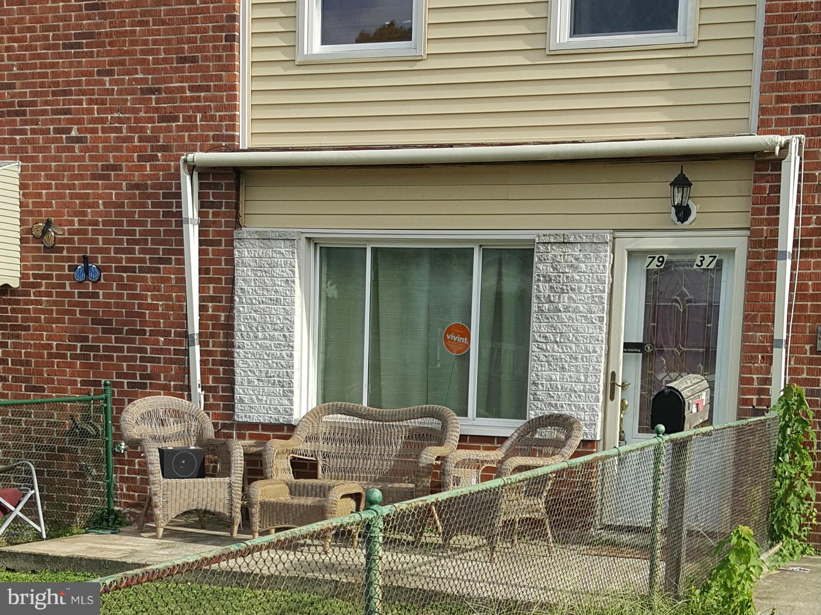 7937 Wynbrook Road Baltimore, MD 21224 - Photo 3 of 3 a front view of a house with outdoor seating