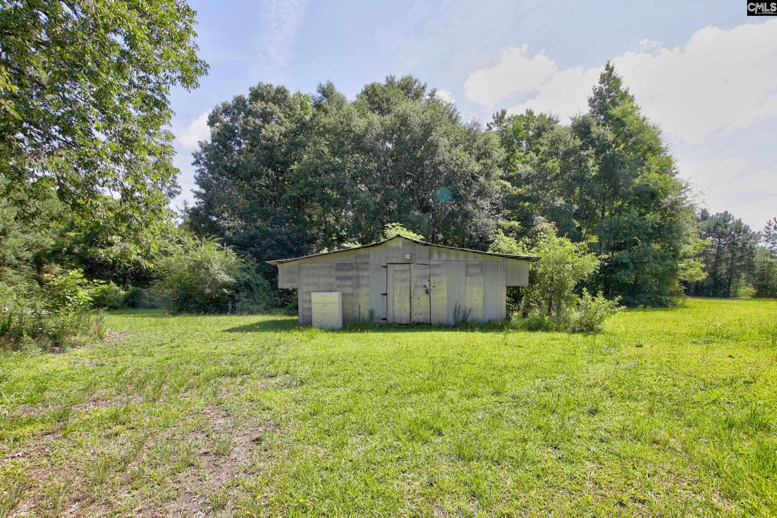 3140 Highway 702 Chappells, SC 29037 - Photo 37 of 39 a white house with a big yard and large trees