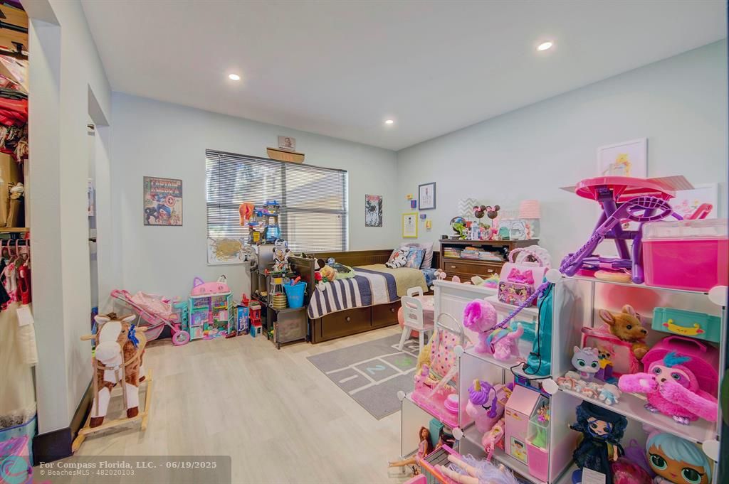 18111 Northwest 68th Avenue, Unit I210 Hialeah, FL 33015 - Photo 11 of 23 a bedroom with furniture and a gym equipment