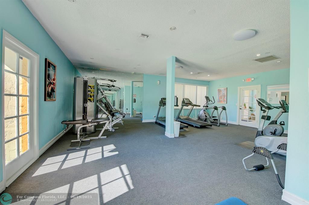 18111 Northwest 68th Avenue, Unit I210 Hialeah, FL 33015 - Photo 19 of 23 a view of a room with gym equipment