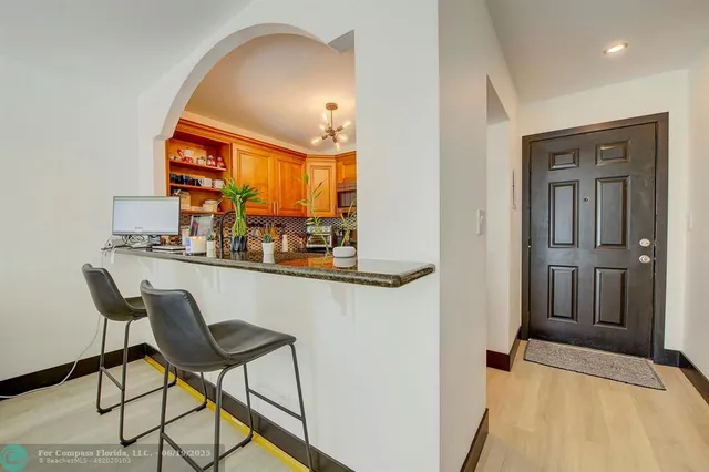 a dining room with furniture and a chandelier