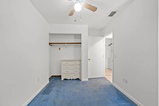 a bedroom with furniture and a large window