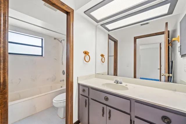 a view of a house with a yard and sitting area