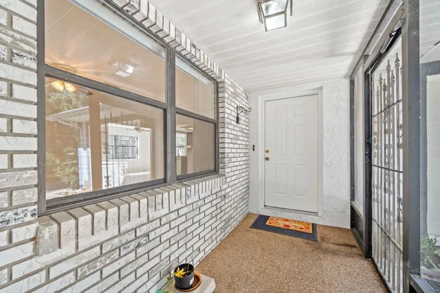 a view of an empty room with window and cabinet