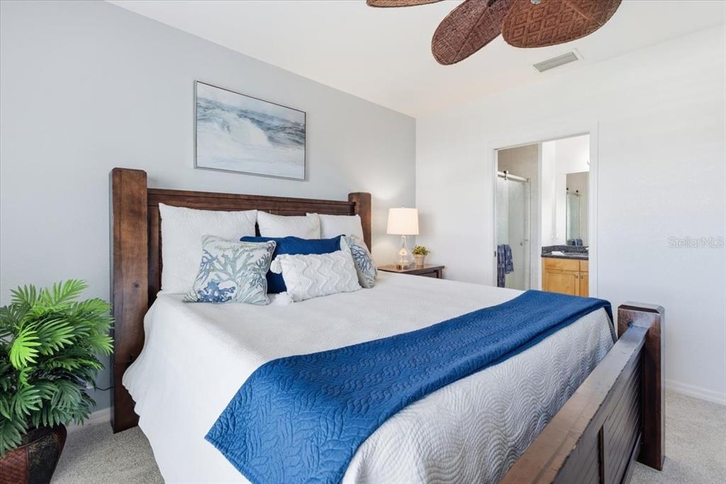 8411 Placida Road, Unit 407 Placida, FL 33946 - Photo 28 of 43 a bedroom with bed and paintings on the wall