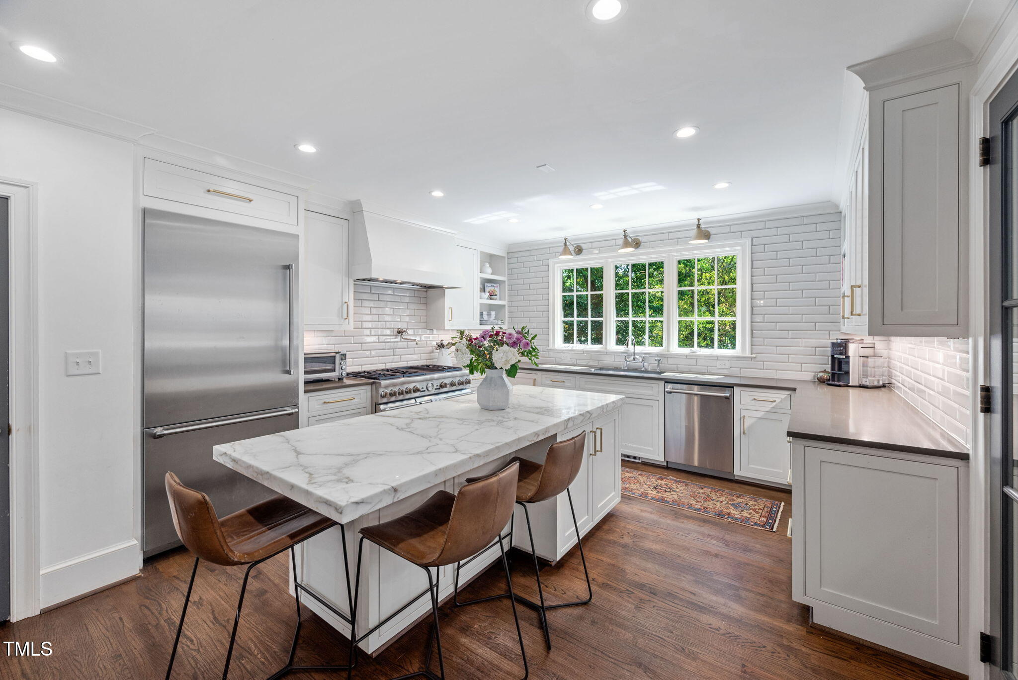 1619 Craig Street Raleigh, NC 27608 - Photo 17 of 49 a kitchen with granite countertop a center island and stainless steel appliances