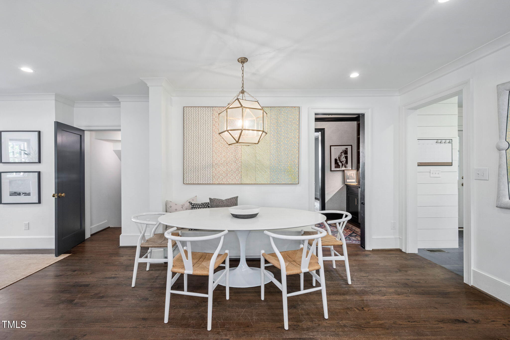 1619 Craig Street Raleigh, NC 27608 - Photo 20 of 49 a dining room with wooden floor a chandelier a wooden table and chairs