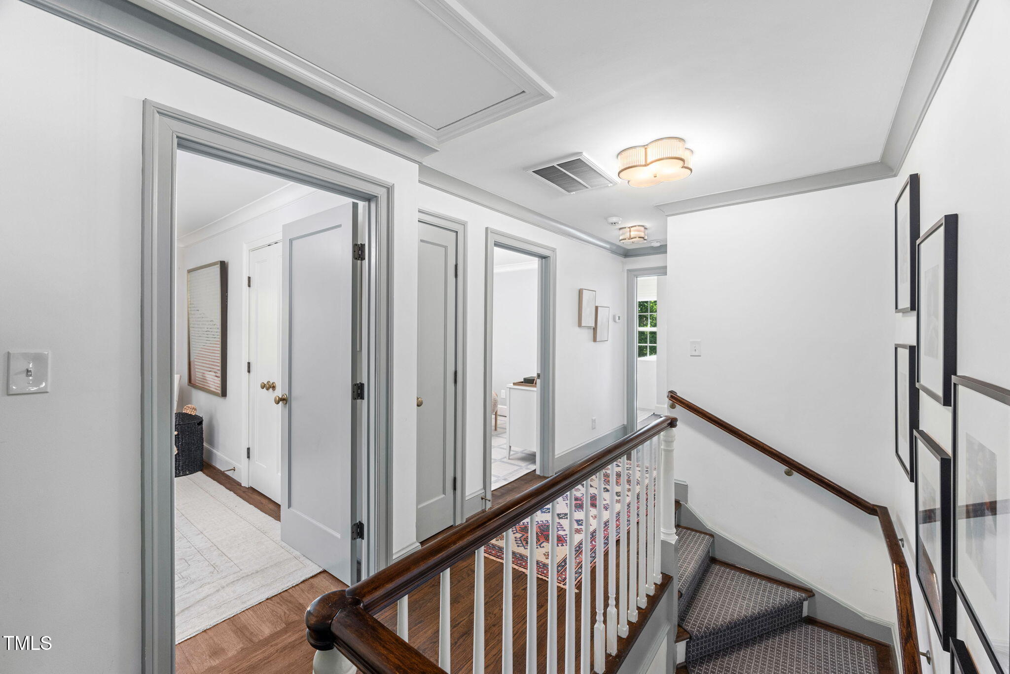 1619 Craig Street Raleigh, NC 27608 - Photo 22 of 49 a view of a hallway with wooden floor and staircase