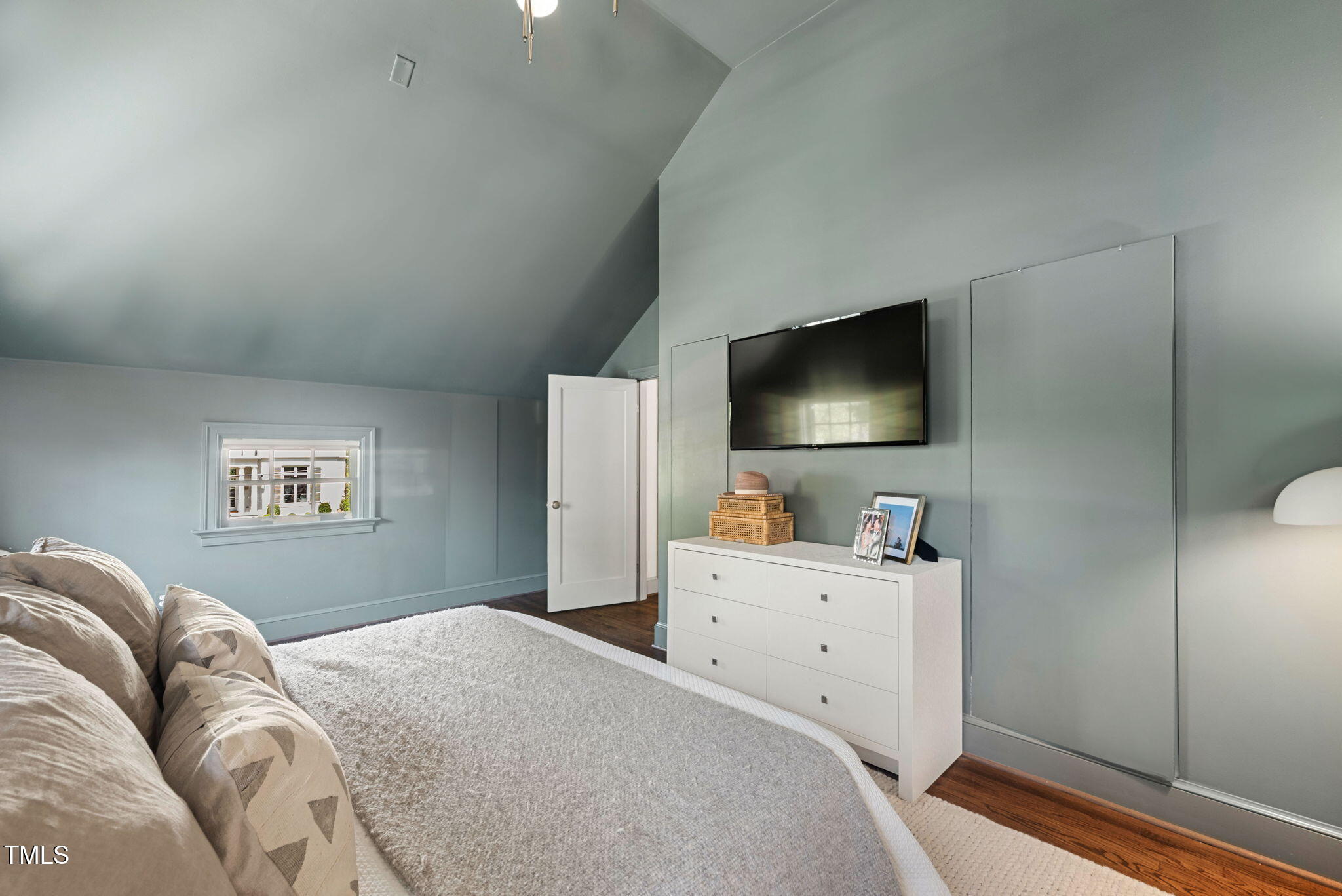 1619 Craig Street Raleigh, NC 27608 - Photo 24 of 49 a bedroom with a bed and a flat screen tv