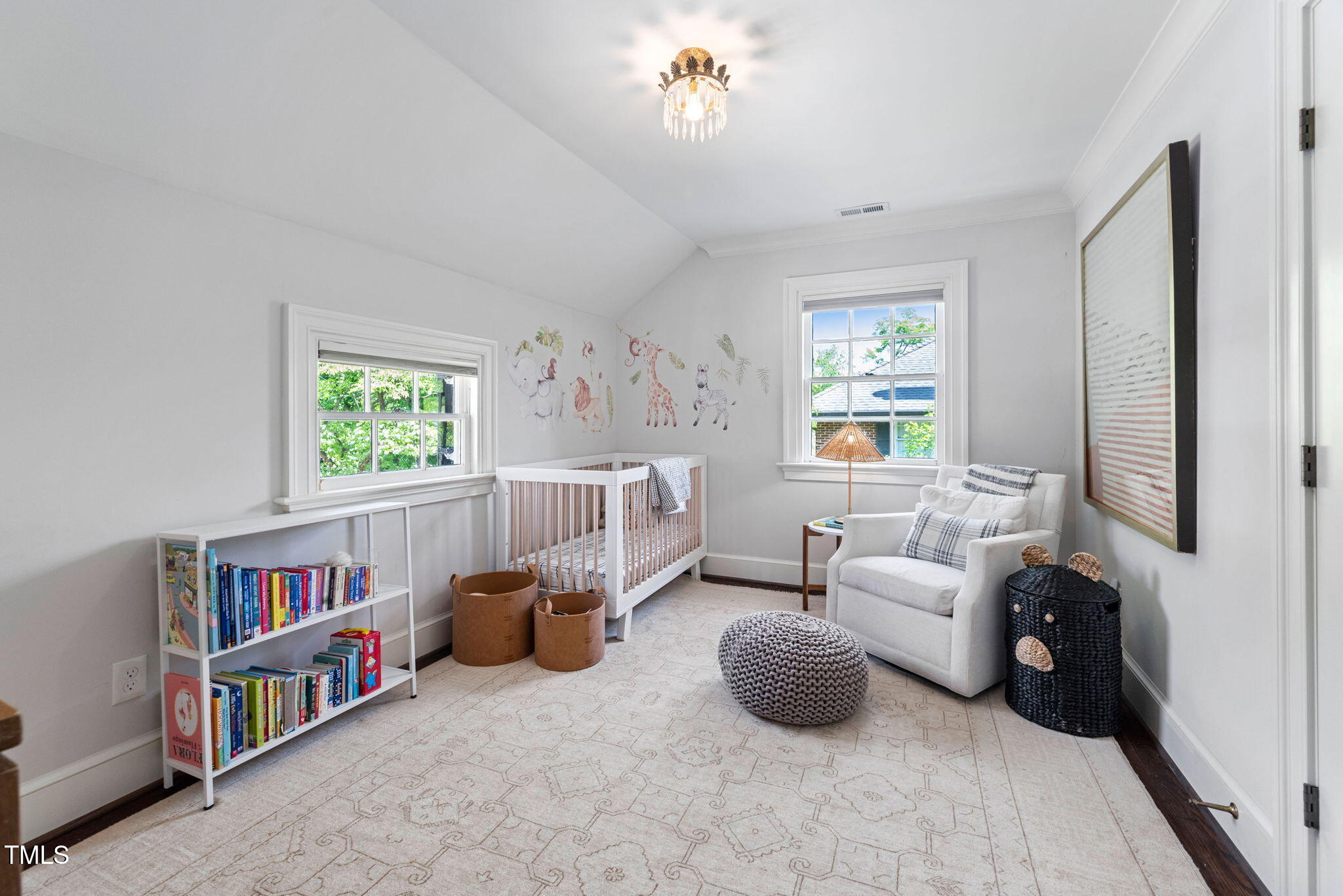 1619 Craig Street Raleigh, NC 27608 - Photo 30 of 49 a living room with a baby crib furniture a chandelier and a book shelf