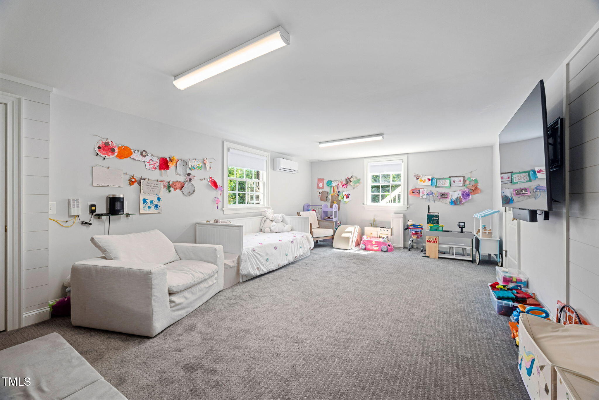 1619 Craig Street Raleigh, NC 27608 - Photo 32 of 49 a living room with furniture and a flat screen tv