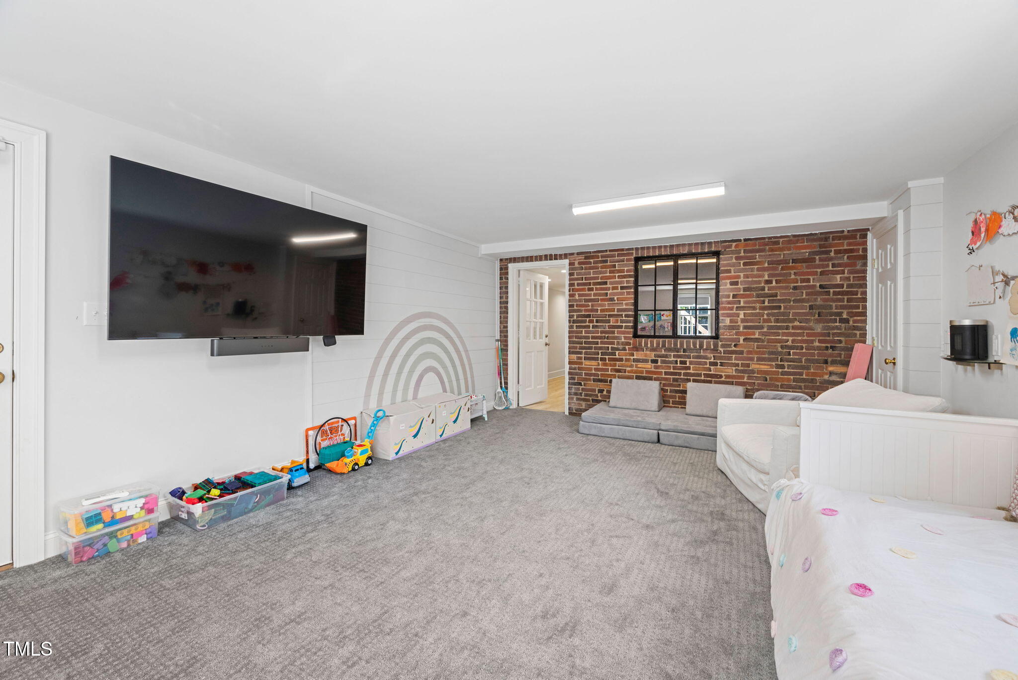 1619 Craig Street Raleigh, NC 27608 - Photo 33 of 49 a bedroom with furniture and a flat screen tv