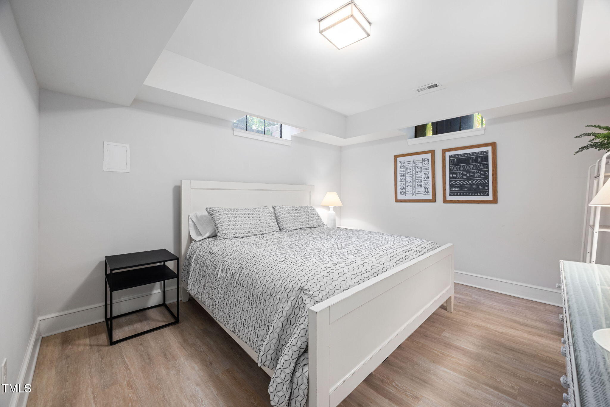 1619 Craig Street Raleigh, NC 27608 - Photo 34 of 49 a bedroom with a bed and a night stand