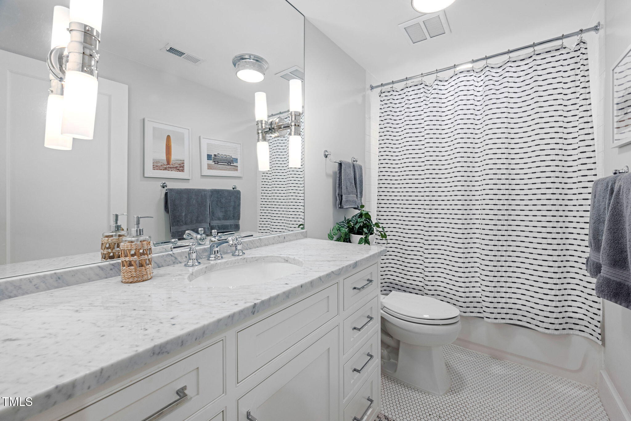 1619 Craig Street Raleigh, NC 27608 - Photo 36 of 49 a bathroom with a granite countertop toilet a sink a mirror and shower curtain