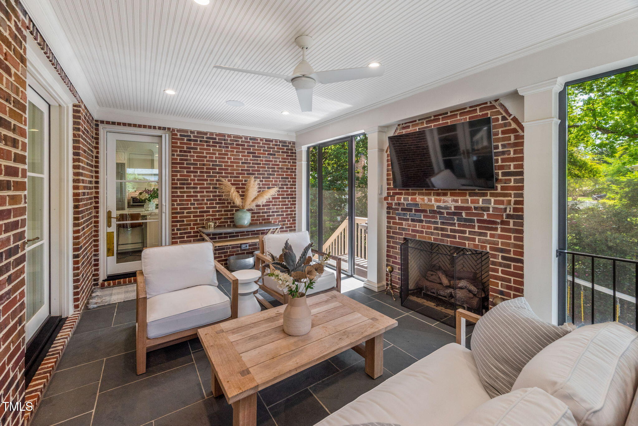1619 Craig Street Raleigh, NC 27608 - Photo 38 of 49 a living room with furniture a flat screen tv and a fireplace
