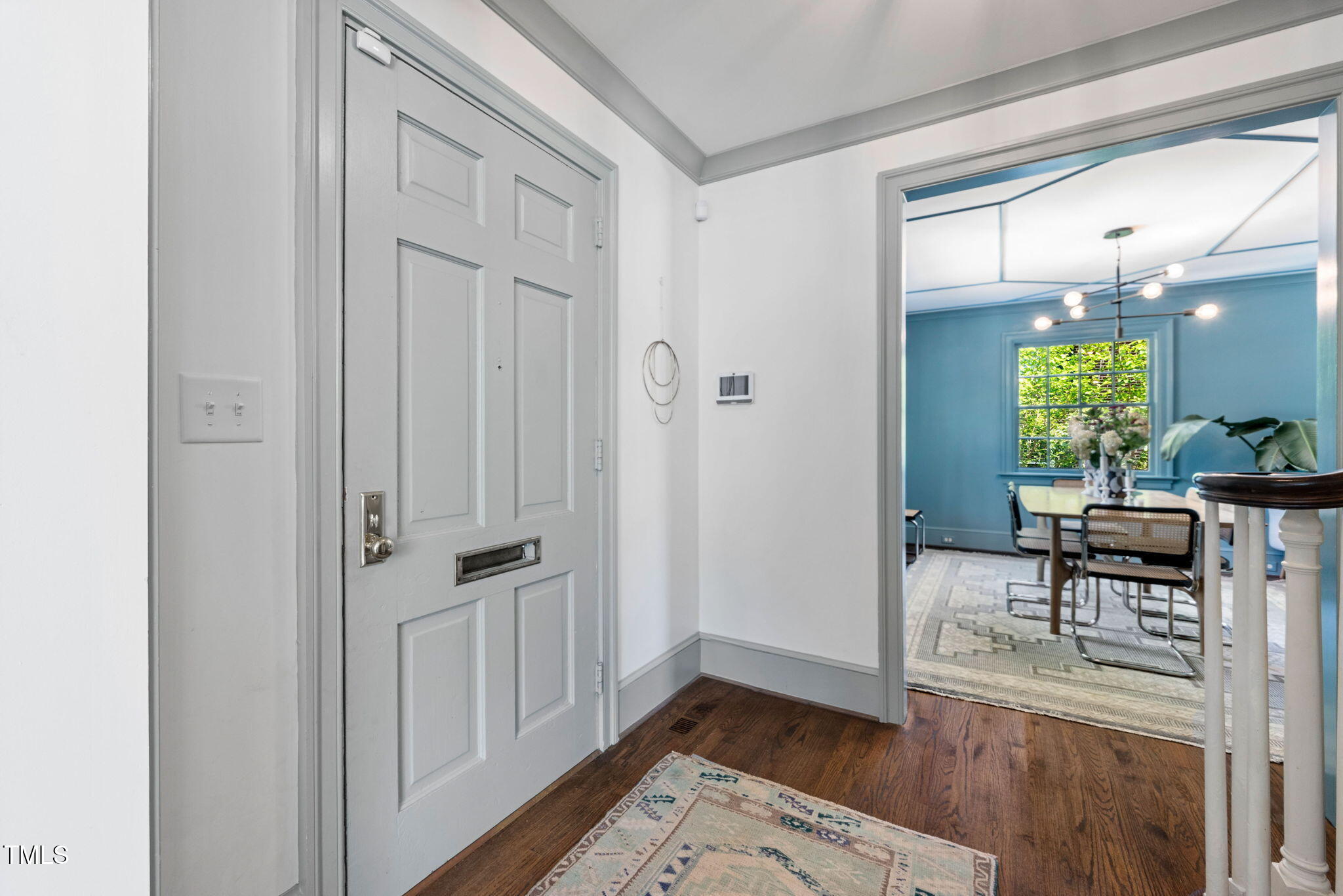 1619 Craig Street Raleigh, NC 27608 - Photo 5 of 49 an entryway with a dining table and chairs