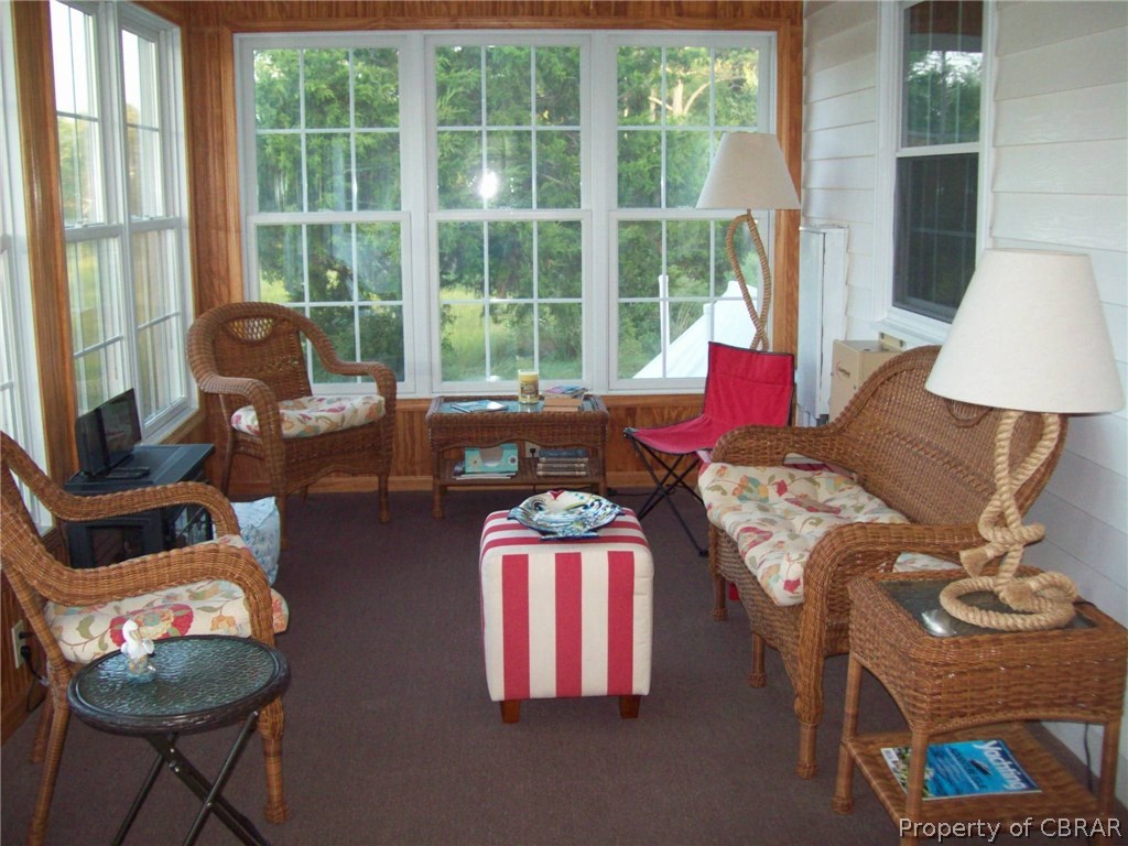 195 Hurst Neck Road Onemo, VA 23130 - Photo 13 of 30 a living room with furniture and a floor to ceiling window