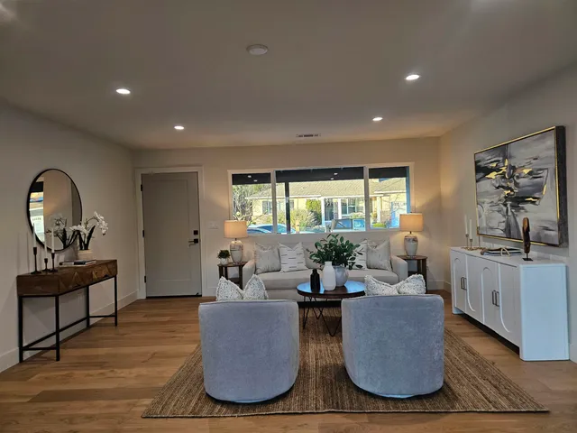 a living room with furniture and a large window