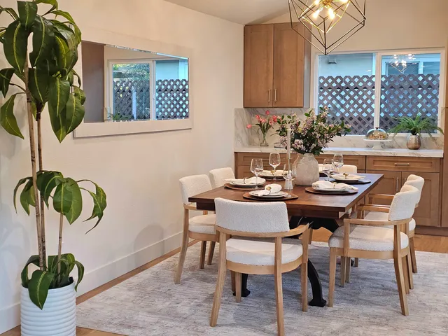 a dining room with furniture and potted plant