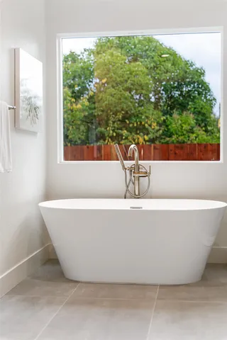a dining room with furniture and a window