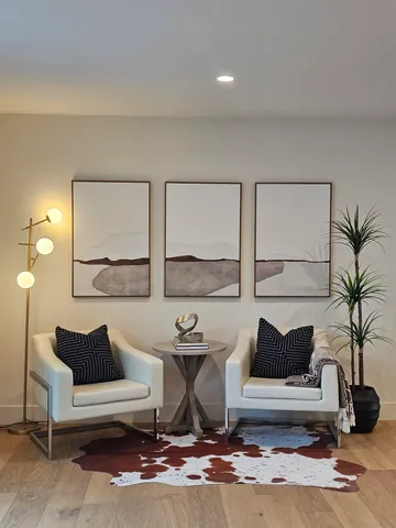 a living room with furniture and a potted plant