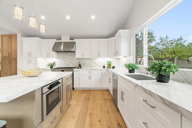 a kitchen with a sink stove and cabinets