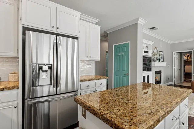 a kitchen with stainless steel appliances granite countertop counter space and a refrigerator