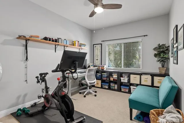 a view of a livingroom with workspace and a window