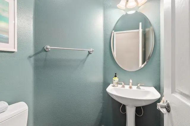 a bathroom with a sink a mirror and a toilet