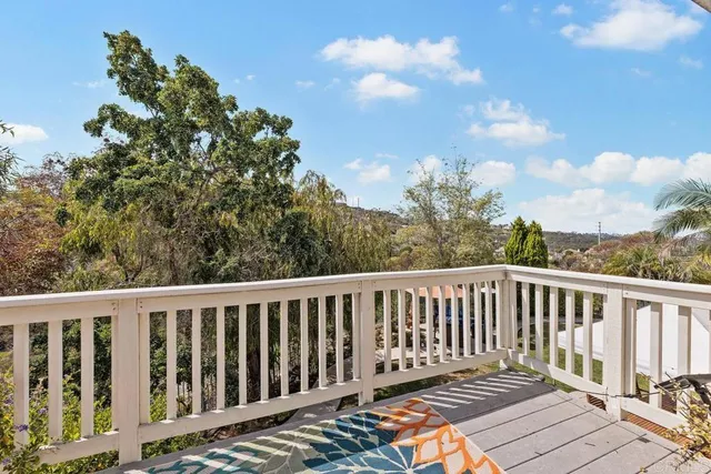 a balcony with wooden floor and fence