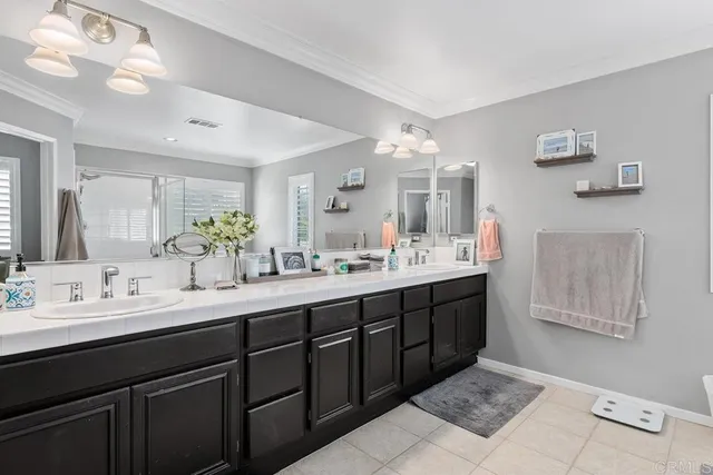 a bathroom with a double vanity sink and a mirror