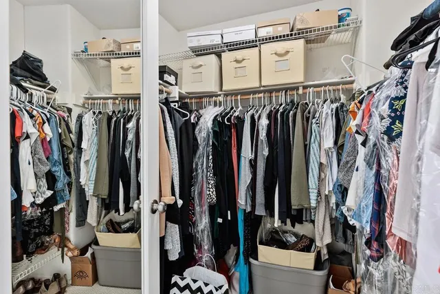 a view of walk in closet with clothes