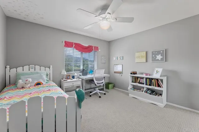 a bedroom with furniture and a large window