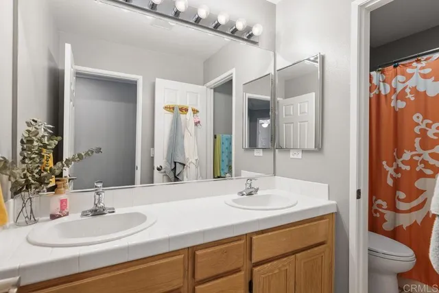 a bathroom with a sink and a mirror with toilet