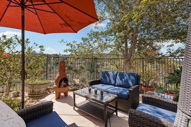 a view of a couches and dinning table in patio