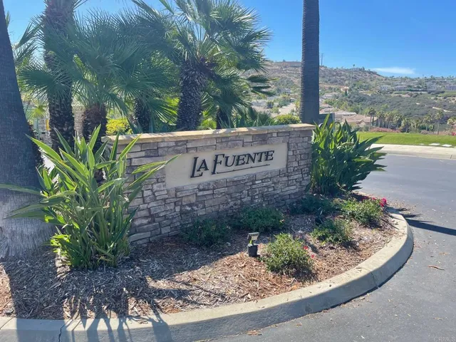 a sign that is sitting on a wooden bench