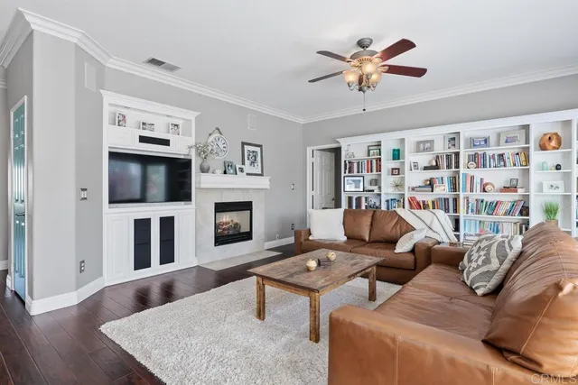 a living room with furniture fireplace and flat screen tv