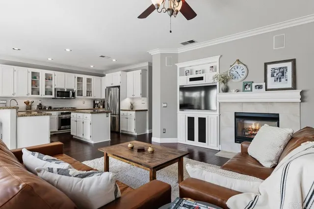 a living room with furniture kitchen view and a fireplace