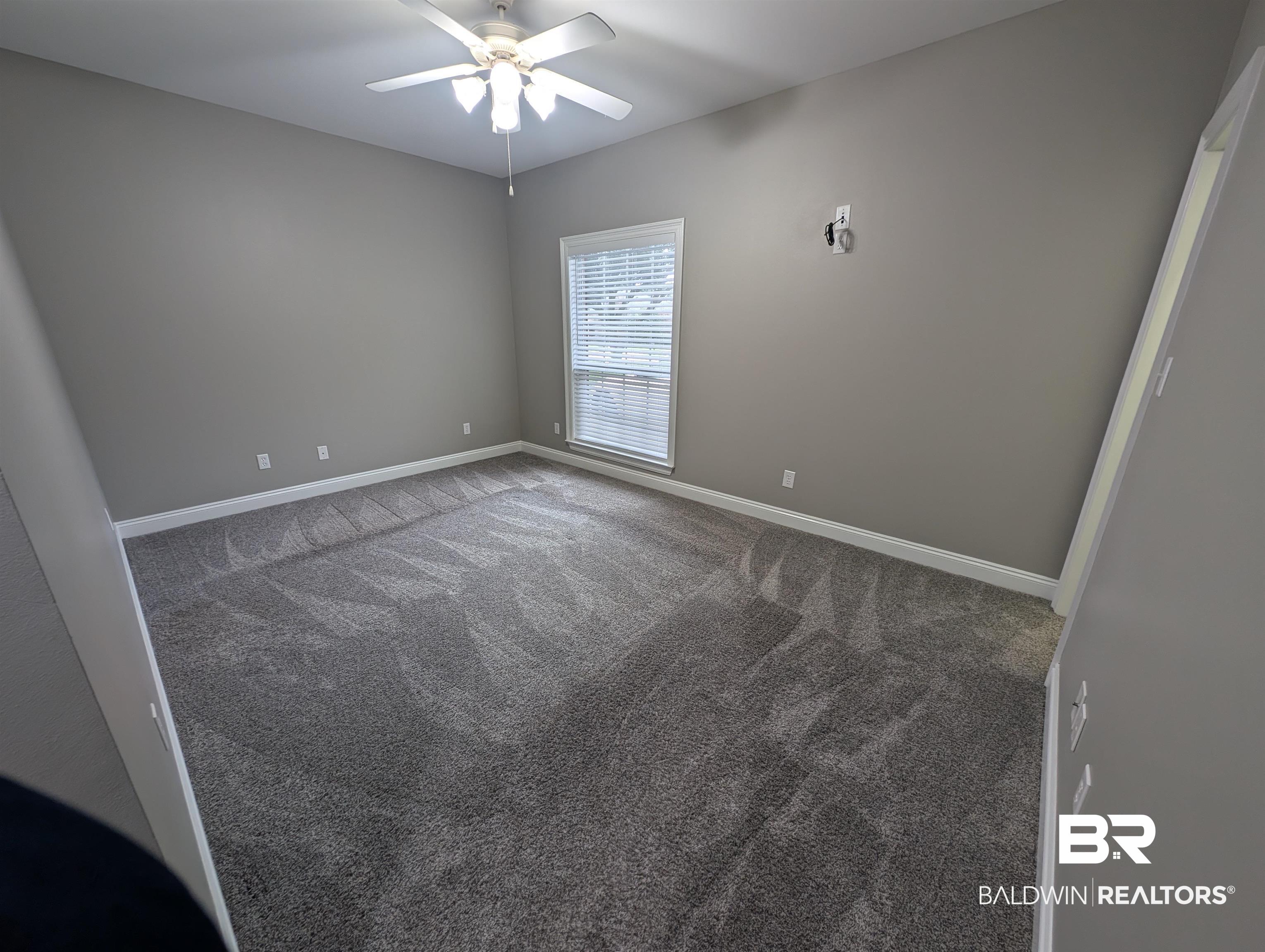 11623 Halcyon Loop Daphne, AL 36526 - Photo 48 of 90 Carpeted Guest bedroom number 3 at the front of the home featuring an oversized window overlooking the driveway featuring ceiling fan