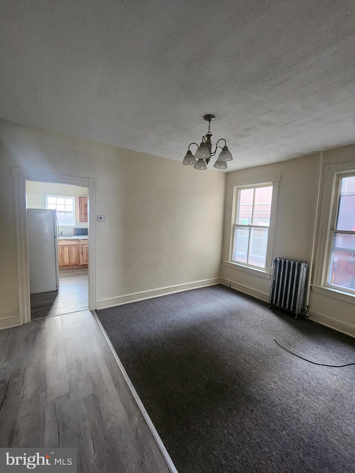 105 Park Street Cumberland, MD 21502 - Photo 3 of 18 wooden floor in an empty room with a window