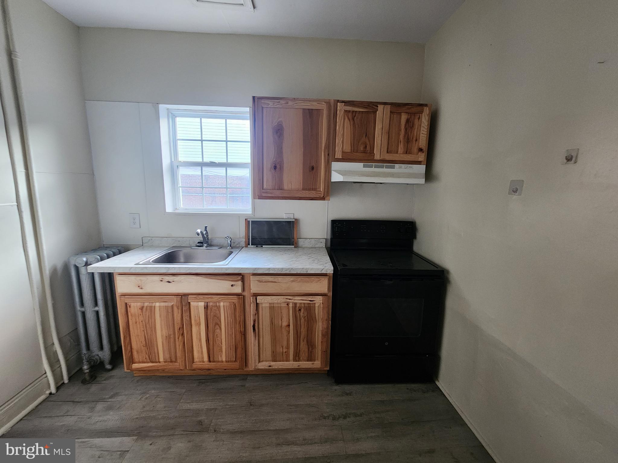 105 Park Street Cumberland, MD 21502 - Photo 4 of 18 a bathroom with a sink and a mirror