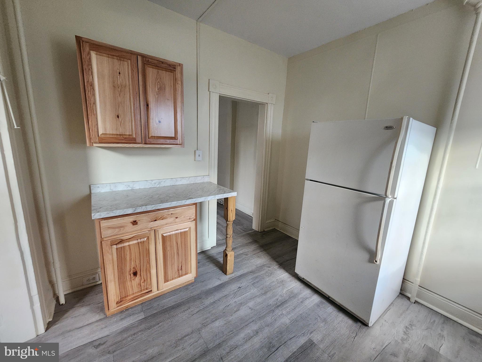 105 Park Street Cumberland, MD 21502 - Photo 6 of 18 a kitchen with stainless steel appliances granite countertop a refrigerator and a sink